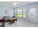 Living room with sofa, coffee table, and large window at 664 Linden Dr, Englewood, FL 34223