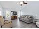 Bright living room with vaulted ceiling, gray sofa, and recliner at 664 Linden Dr, Englewood, FL 34223