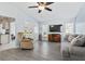 Bright living room with vaulted ceiling, gray sofa, and recliner at 664 Linden Dr, Englewood, FL 34223