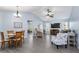 Bright living room with vaulted ceiling, gray sofa, and recliner at 664 Linden Dr, Englewood, FL 34223