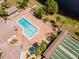 Community pool and shuffleboard courts near a lake at 664 Linden Dr, Englewood, FL 34223