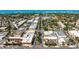 Expansive aerial view of a bustling city showcasing streets lined with lush green trees at 840 The Esplanade N # 104, Venice, FL 34285