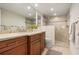 Modern bathroom featuring double vanity, large mirror, and glass shower at 840 The Esplanade N # 104, Venice, FL 34285