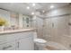 Bright bathroom features a glass shower with neutral tile and granite countertops at 840 The Esplanade N # 104, Venice, FL 34285