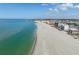 Picturesque shoreline aerial view of a sunny beach with turquoise water and nearby buildings at 840 The Esplanade N # 104, Venice, FL 34285