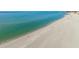 Sunny aerial view of a tranquil beach with turquoise water and a person in the distance at 840 The Esplanade N # 104, Venice, FL 34285