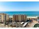 Wide view of a building near the beach with a parking lot and construction area in front at 840 The Esplanade N # 104, Venice, FL 34285