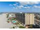 An aerial view of a high-rise building close to the beach and clear blue skies on a sunny day at 840 The Esplanade N # 104, Venice, FL 34285