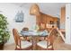 Cozy dining area with wicker chairs, glass table, and nautical decor at 840 The Esplanade N # 104, Venice, FL 34285