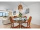 Dining area with water view and a glass table with wicker chairs at 840 The Esplanade N # 104, Venice, FL 34285