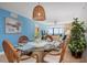Bright dining area boasts ocean view, coastal decor, and a wicker pendant light fixture at 840 The Esplanade N # 104, Venice, FL 34285