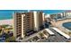 An exterior view of a multi-story building with beachfront access and parking at 840 The Esplanade N # 104, Venice, FL 34285