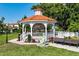 Classic white gazebo featuring park benches and a whimsical statue in a serene green space at 840 The Esplanade N # 104, Venice, FL 34285