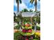 Artistic landscaping and street view featuring vibrant flowers and greenery to enjoy near the local real estate at 840 The Esplanade N # 104, Venice, FL 34285