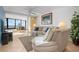 Comfortable living room with ocean view, neutral colors, and a sliding glass door to balcony at 840 The Esplanade N # 104, Venice, FL 34285