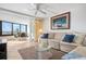 Cozy living room with ocean view, a ceiling fan, and a glass coffee table at 840 The Esplanade N # 104, Venice, FL 34285