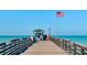 Picturesque pier with a snack shop and people enjoying the stunning ocean view at 840 The Esplanade N # 104, Venice, FL 34285