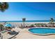 Beautiful beachside pool with lounge seating and umbrella, offering relaxation with ocean views at 840 The Esplanade N # 104, Venice, FL 34285