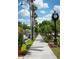 Beautiful sidewalk along the street showing landscaping, street clock, and seating for enjoying this real estate at 840 The Esplanade N # 104, Venice, FL 34285