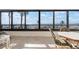 Relaxing space with dining table and chairs offers clear beach views through large windows at 840 The Esplanade N # 104, Venice, FL 34285