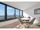 Sitting area with dining table and chairs, plus scenic beach views through large windows at 840 The Esplanade N # 104, Venice, FL 34285