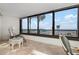 Serene room with cozy seating, showcasing stunning beach views through expansive windows at 840 The Esplanade N # 104, Venice, FL 34285