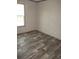 Spacious bedroom with wood-look flooring and large window at 8426 Sweden Blvd, Punta Gorda, FL 33982