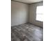 Simple bedroom with wood-look flooring and a window at 8426 Sweden Blvd, Punta Gorda, FL 33982