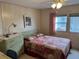 Bright bedroom with a double bed, dresser, and window at 863 Baveno Dr, Venice, FL 34285
