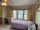 Bright bedroom with twin beds, window seat, and wicker furniture at 863 Baveno Dr, Venice, FL 34285