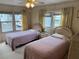 Bedroom with two twin beds and window at 863 Baveno Dr, Venice, FL 34285