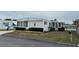 Single-wide manufactured home with water view and landscaping at 863 Baveno Dr, Venice, FL 34285