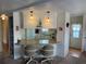 Kitchen with breakfast bar and white cabinetry at 863 Baveno Dr, Venice, FL 34285