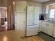 Kitchen boasts white cabinets and a refrigerator at 863 Baveno Dr, Venice, FL 34285