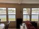 Living room with lake view, comfy seating, and a large TV at 863 Baveno Dr, Venice, FL 34285