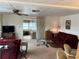 Living room with a maroon couch and access to a sunroom at 863 Baveno Dr, Venice, FL 34285