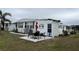 Small patio furniture set next to manufactured home at 863 Baveno Dr, Venice, FL 34285