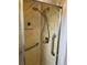 Walk-in shower with grab bars and tiled walls at 863 Baveno Dr, Venice, FL 34285