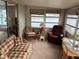 Bright sunroom with water views and comfortable seating at 863 Baveno Dr, Venice, FL 34285