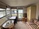 Versatile sunroom with sofa, table, and storage at 863 Baveno Dr, Venice, FL 34285