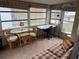 Sunroom with table, chairs, and workspace at 863 Baveno Dr, Venice, FL 34285