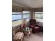 Relaxing sunroom with lake view and comfortable seating at 863 Baveno Dr, Venice, FL 34285