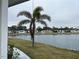 Calm lake view with several manufactured homes at 863 Baveno Dr, Venice, FL 34285