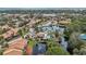 Aerial view of a community featuring a pool, lake, and surrounding buildings at 958 Sunridge Dr # H3, Sarasota, FL 34234