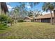 Large grassy backyard with mature trees at 958 Sunridge Dr # H3, Sarasota, FL 34234