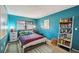 Bright bedroom with teal walls and ample storage at 958 Sunridge Dr # H3, Sarasota, FL 34234