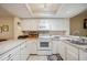 White kitchen with appliances and ample counter space at 958 Sunridge Dr # H3, Sarasota, FL 34234