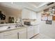 Bright kitchen with white cabinets, appliances, and tile floor at 958 Sunridge Dr # H3, Sarasota, FL 34234