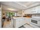 Open kitchen with white cabinets and appliances at 958 Sunridge Dr # H3, Sarasota, FL 34234
