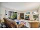 Living room with brown couch, access to patio, and TV at 958 Sunridge Dr # H3, Sarasota, FL 34234